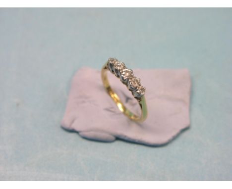 An 18ct. gold and diamond half-hoop ring, five small diamonds, platinum claw settings, size L