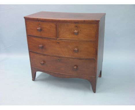 An early Victorian bow-fronted mahogany chest, two short and two long oak-lined drawers, turned wood knob handles, splay brac