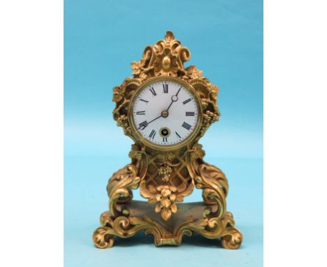 A late 19th century French ormolu mantel clock, cast with leafage, berries and C-scrolls in rococo-style, French timepiece mo