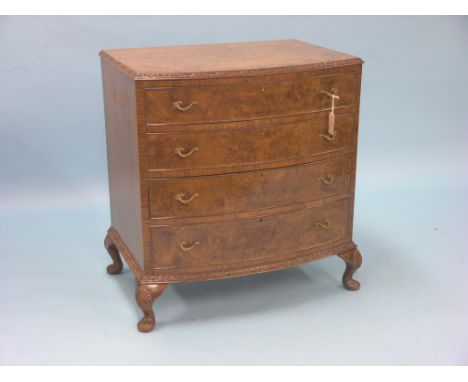 A reproduction burr walnut chest, bow-fronted with four long drawers, carved borders, cabriole feet, 2ft. 6in.