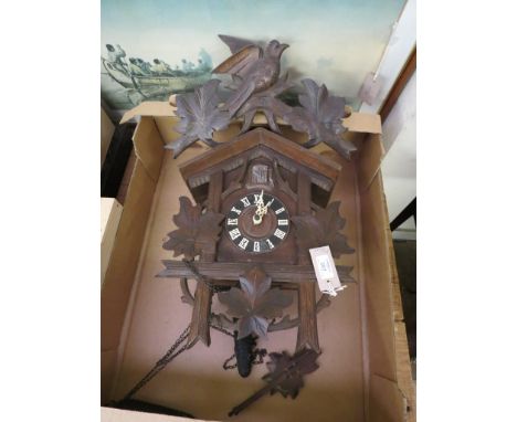A Black Forest cuckoo clock, with carved leaf and bird cresting, gong-striking, with pendulum and cone weights, 18in. high, t