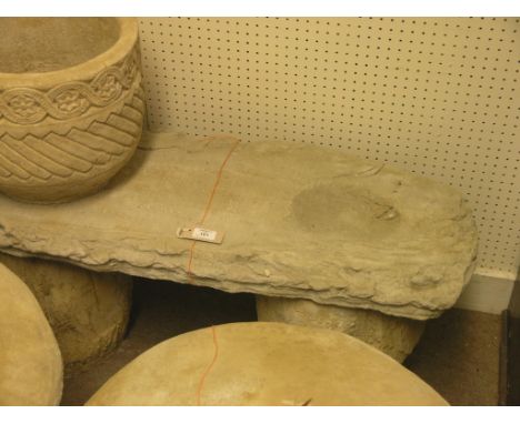 A moulded concrete garden bench, twin-seater on log-effect supports 