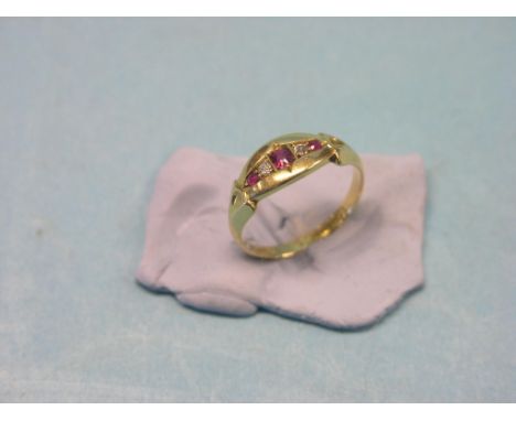 An 18ct. gold half-hoop ring, set three rubies and two diamond chips, size M/N