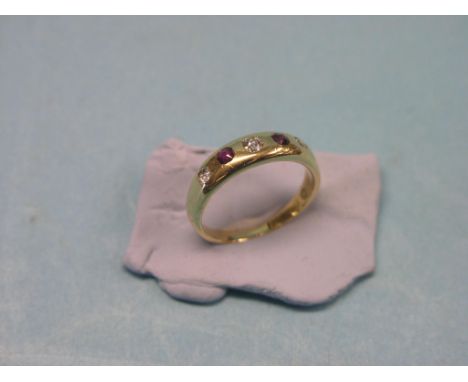 An 18ct. gold, diamond and ruby ring, three small diamonds, two small rubies in gypsy setting, size K/L