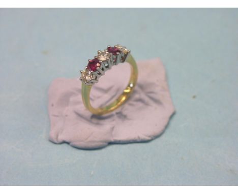 An 18ct. gold half-hoop ring, three diamonds, two rubies, claw settings, size L/M