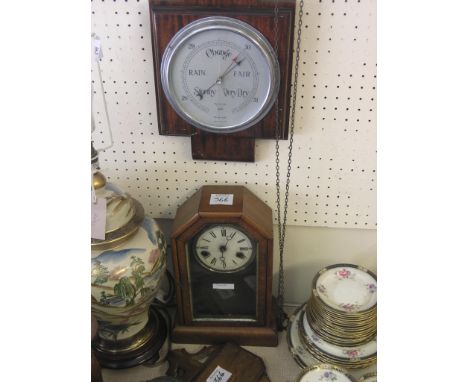A 19th century American walnut mantel clock, enclosed by arched door, with key and pendulum, 12.5in., a mahogany wheel barome