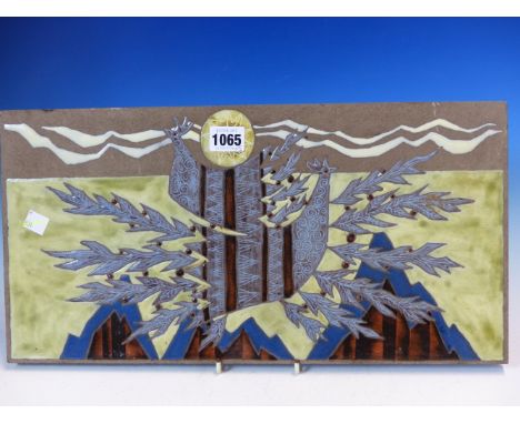 A FRENCH POTTERY PLAQUE, ENAMELLED WITH TWO BIRDS IN FLIGHT FLYING OVEER MOUNTAINS, SIGNED JAFFEUX. 23 x 45cms. TOGETHER WITH