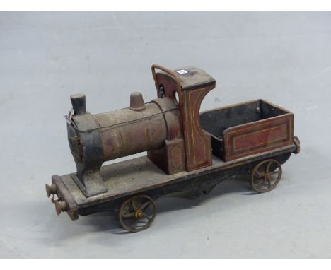 A RED PAINTED WOOD PULL ALONG STEAM ENGINE WITH SPOKED IRON WHEELS AND BEARING ALUMINIUM TRIANGLE ON THE FUNNEL, POSSIBLY FOR