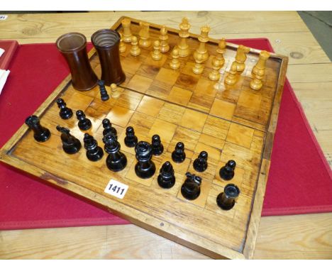 A STAUNTON BOX AND EBONY CHESS SET, THE KINGS. H 8.5cms. A PAIR OF TURNED WOOD DICE SHAKERS, ALL CONTAINED IN A FOLDING BOARD