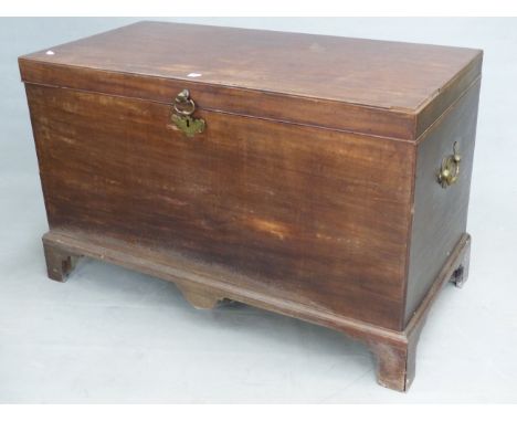 A GEORGIAN&nbsp; MAHOGANY COFFER, RECTANGULAR HINGED LID,&nbsp; BRASS HANDLES, BRACKET FEET. W 123 x D 62 x H 76cms