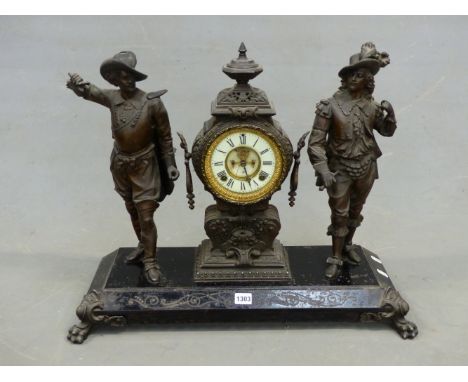 AN ANSONIA CLOCK FLANKED BY TWO SPELTER CAVALIER FIGURES STANDING ON AN IRON PLINTH ON PAW FEET. W 65 x H 53cms.