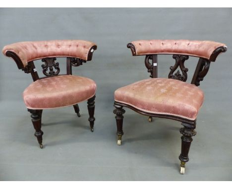 TWO SIMILAR MAHOGANY VICTORIAN DESK ARMCHAIRS, THE HOOP TOP RAILS BUTTON UPHOLSTERED OVER FOLIATE CARVED SPLATS BETWEEN CHANN