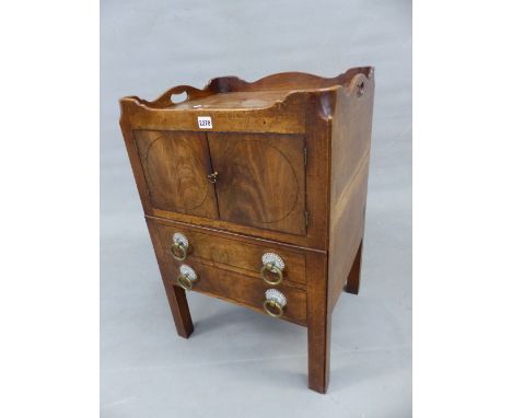 A GEORGE III MAHOGANY NIGHT TABLE, TWO HANDLES PIERCED INTO THE GALLERIED TOP ABOVE DOORS STRUNG WITH CIRCLES, THE DRAW OUT B