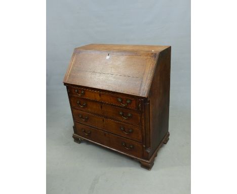A GEORGE III OAK BUREAU, THE FALL AND FOUR GRADED DRAWERS WITH MAHOGANY BANDING ABOVE BRACKET FEET, THE INTERIOR WITH A CONFI