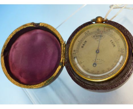 A LEATHER CASED WEST POCKET BAROMETER, THE TOP ARC OF THE SILVERED DIAL WITH BAROMETRIC READING THE BOTTOM ARC WITH A MERCURY