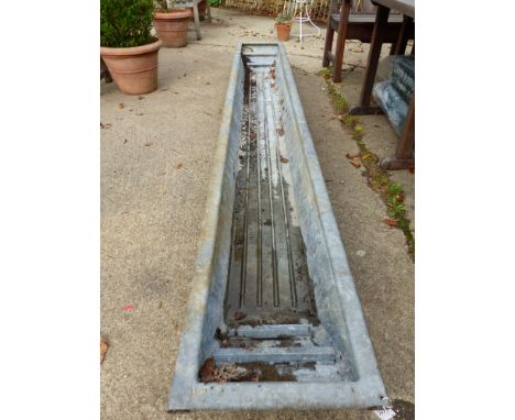 A LONG GALVANISED TROUGH.