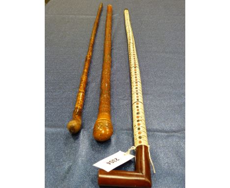 A WOODEN HANDLED STING RAY SPINE WALKING STICK.   H 93cms,, A BAMBOO WALKING CANE TOGETHER WITH A JAPANESE CARVED BAMBOO WALK