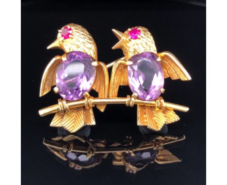 TWO BIRDS ON A BRANCH BROOCH, 18ct GOLD FORMS WITH AMETHYST BODIES AND RUBY EYES. APPROX 4cms X 3cms. GROSS WEIGHT 12.3grms. 