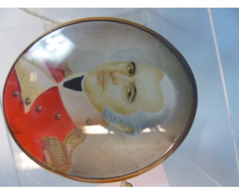 A GEORGIAN OVAL MINIATURE PORTRAIT OF A MILITARY OFFICER IN RED UNIFORM.  YELLOW METAL ENCLOSED FRAME.  7 x 6cms. 