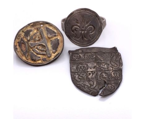 A MEDIAEVAL WHITE METAL SHIELD BEARING THE ARMS OF BARON DE LA POLE.   H 3cms. AN ANGLO SAXON WHITE METAL ROUND BROOCH WITH A
