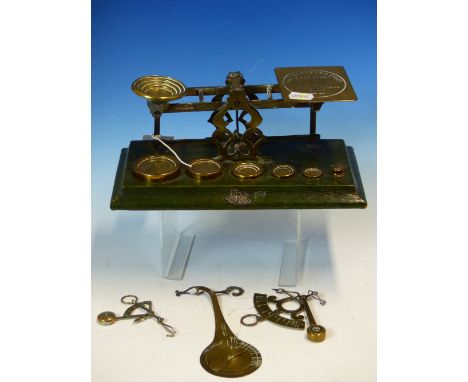 FOUR LETTER SCALES, THE LARGEST BY SAMSON MORDAN WITH SIX BRASS WEIGHTS RESTING ON THE GREEN LEATHER MOUNTED BASE.   W 26.5cm