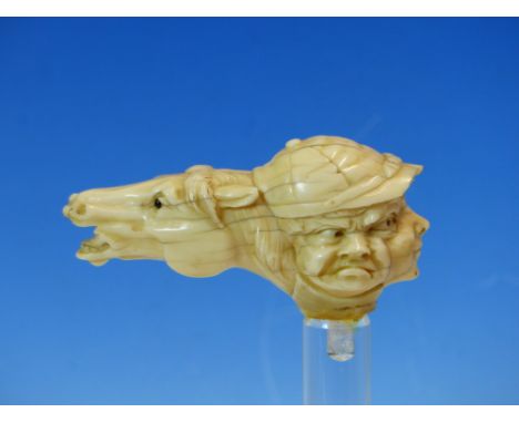 A MARINE IVORY WALKING STICK HANDLE CARVED AS A RACE HORSE HEAD TO ONE SIDE OF THREE JOCKEY FACES, SAD, CONCENTRATING AND HAP