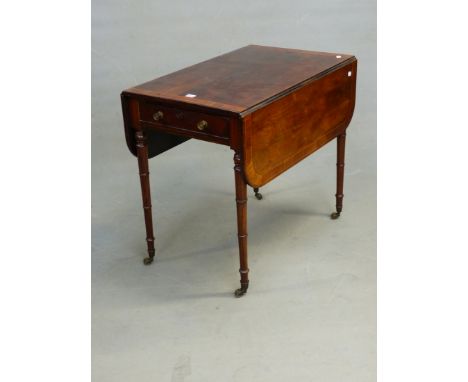 A REGENCY ROSEWOOD AND CROSS BANDED PEMBROKE TABLE WITH END DRAWER, ON RING TURNED LEGS WITH BRASS CASTORS.  81 x 106 x 71cm 