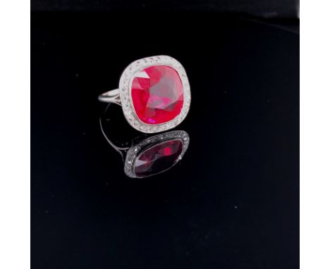 PLATINUM, DIAMOND AND SYNTHETIC RUBY CUSHION SHAPE CLUSTER. THE CENTRAL RUBY SURROUNDED BY THIRTY ROSE CUT DIAMONDS. FINGER S