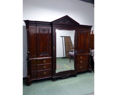 A GOOD 19TH.C. MAHOGANY COMPACTUM IN THE ARCHITECTURAL NEO-CLASSICAL TASTE. CARVED ARCH PEDIMENT OVER CENTRAL MIRROR DOOR ENC