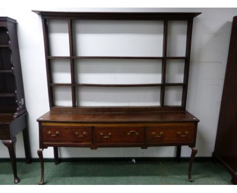 AN 18TH C.AND LATER OAK THREE DRAWER DRESSER WITH OPEN THREE SHELF BACK AND ON CABRIOLE FRONT LEGS WITH CLAW FEET. W 182 x D 