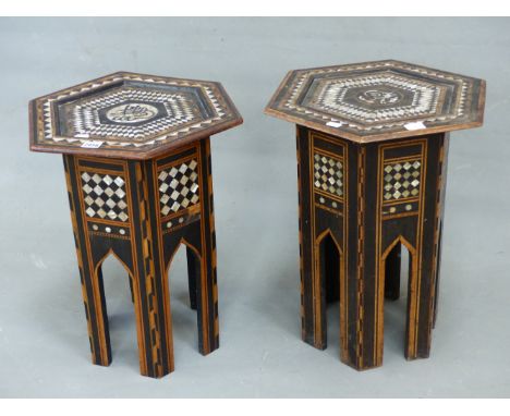 AN ISLAMIC HEXAGONAL TABLE, THE BANDS OF GEOMETRIC INLAY TO THE TOP ENCLOSING A ROUNDEL OF EBONY SCRIPT ON MOTHER OF PEARL. W