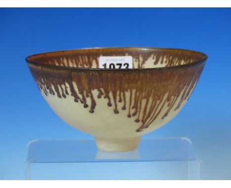 A DAVID FRITH BOWL, THE RIM OF THE CREAM GLAZED BODY BROWN WITH PENDANT DRIPS IN THE LUCIE RIE TASTE, SIGNED FRITH ON THE FOO