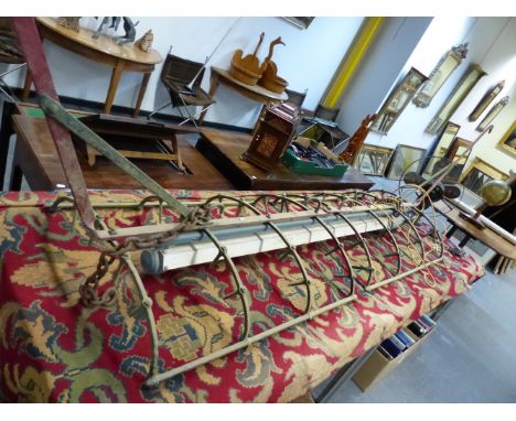 AN INTERESTING INDUSTRIAL KITCHEN /SCULLERY HANGING LIGHT CONSTRUCTED AROUND AN ANTIQUE POTATO HARROW OF CURVED FORM