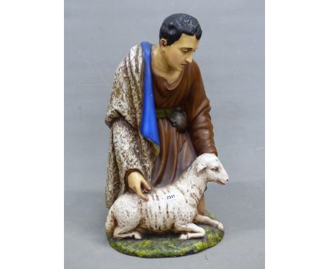 A&nbsp; CERAMIC FIGURE OF A SHEPHERD KNEELING BY A SHEEP, HIS BLUE LINED CLOAK OVER HIS RIGHT SHOULDER. H 71cms.