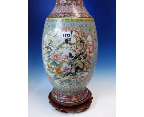 A CHINESE FAMILLE ROSE VASE WITH WOOD STAND, THE BALUSTER SHAPE PAINTED WITH RESERVES OF FLOWERS AND BIRDS ON A TURQUOISE GRO