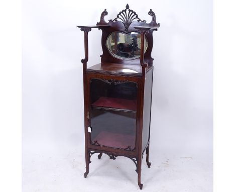 An Edwardian mahogany music cabinet, with a raised mirrored shelf-back and glazed door, W54cm, H152cm, D41cm 