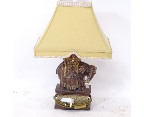 A decorative composite table lamp and shade, in the form of an Indian elephant, height including shade 53cm (1 tusk missing) 