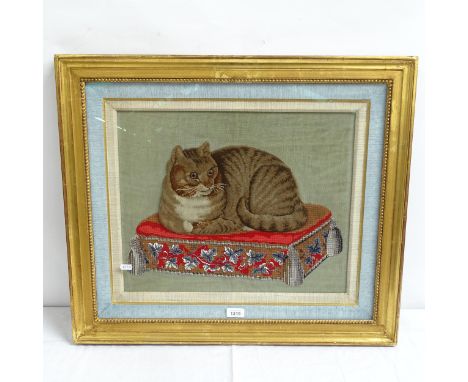 An embroidered stumpwork panel, cat on stool, framed, overall 60cm x 70cm 
