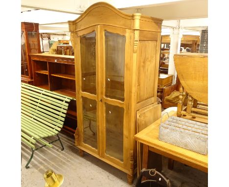 A arch-top pine 2-door cabinet, with fitted rail and loose shelves, W105cm, H200cm, D55cm 