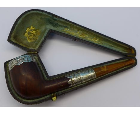 A pipe with silver embellishments, cased