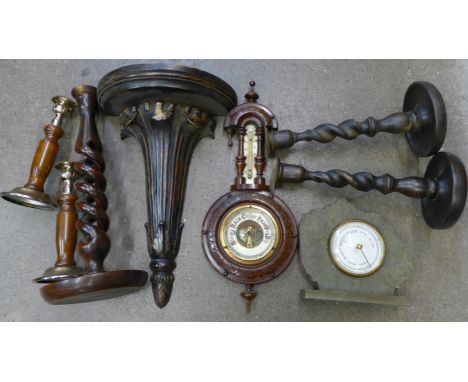 A pair of wooden candlesticks, two other wooden candlesticks including open barleytwist, a wall bracket, aneroid barometer an