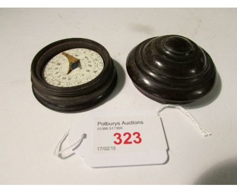 Pocket magnetic sundial in treen case (perhaps coromandel), the printed card dial (diameter 3.9cm) on a gimbal balance with b