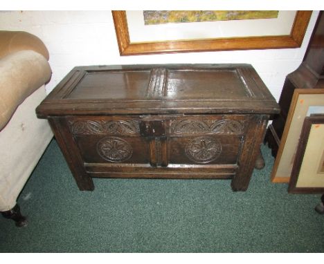 18th century oak coffer with two-panel lid on loop and eye iron hinges, the front panels carved with floral medallions and th