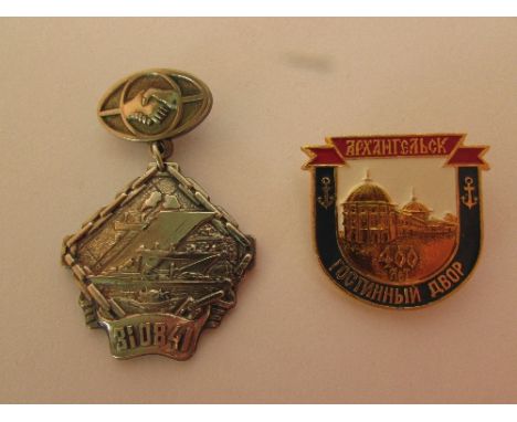 Russian white medal badge embossed with ships and 310841 and a Russian enamel badge depicting building and anchors [the white