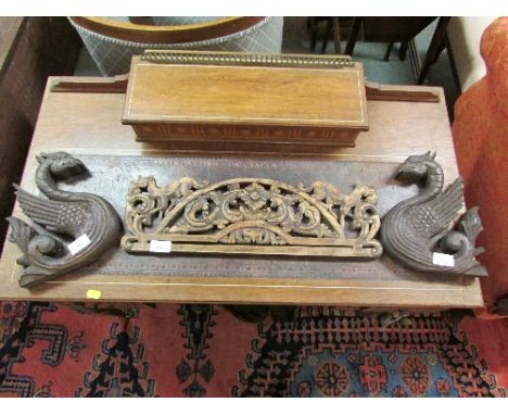 A pair of sectional carved wooden dragons (height 25cm), a heavily carved clock bracket (46cm), and a carved wood pediment de