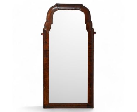 George II walnut cushion framed wall mirror, moulded frame with shaped upper corners, bevelled mirror plateDimensions: Height