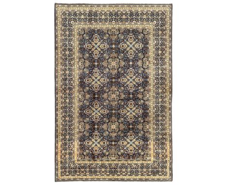 Persian indigo and pale gold ground rug, overall busy geometric design, the field decorated with hooked Hac and palmette meda