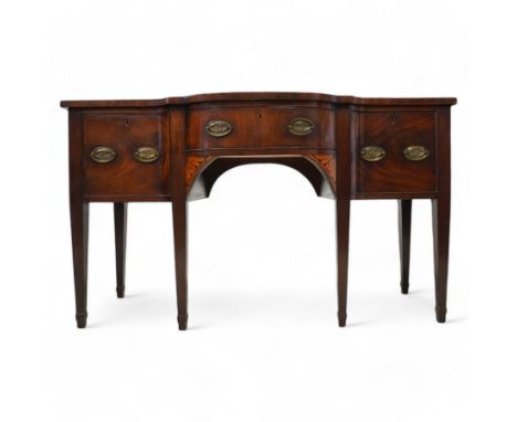 George III mahogany break bow-front sideboard, fitted with three drawers, the corner brackets inlaid with quarter shell motif