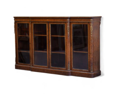 Victorian figured walnut and gilt metal mounted breakfront bookcase, satinwood banded top with gilt metal edging, the frieze 