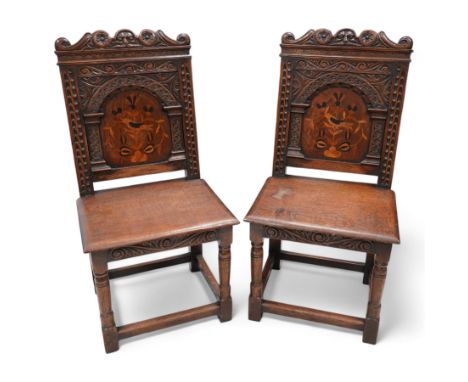 Pair of 19th century Dutch style marquetry oak hall chairs, cresting rail carved with a central green man mask with flanking 